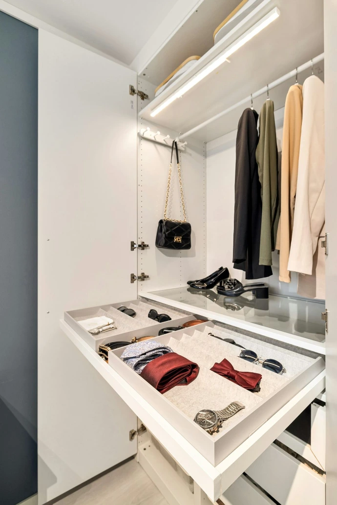 A walk in closet with a white counter top