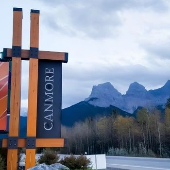Canmore sign with mountains in the background